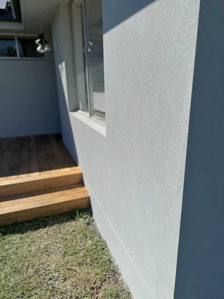 Textured render finish around residential window